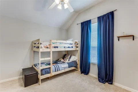 a bed room with a bed and a window