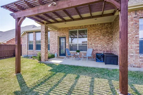 a view of a patio with table and chairs and potted plants