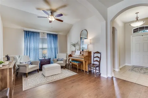 a living room with furniture and wooden floor