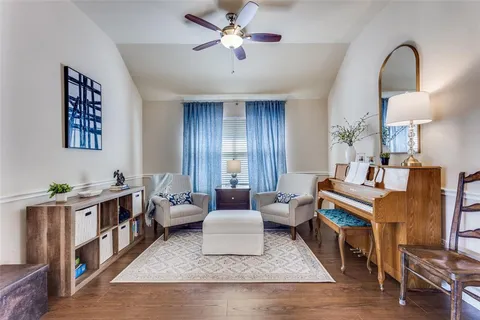 a living room with furniture and wooden floor
