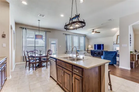a kitchen with a table chairs and a chandelier