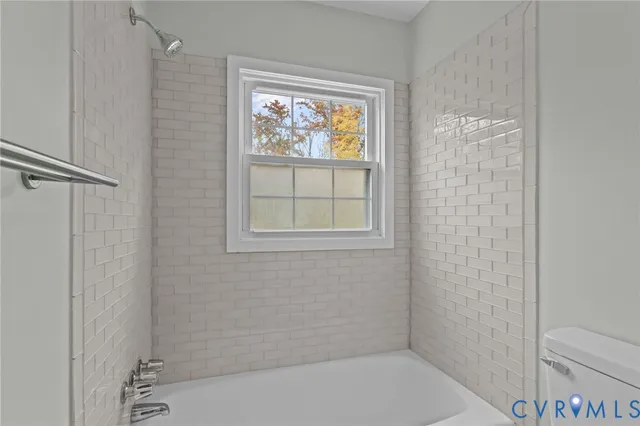 a bathroom with a bathtub and window