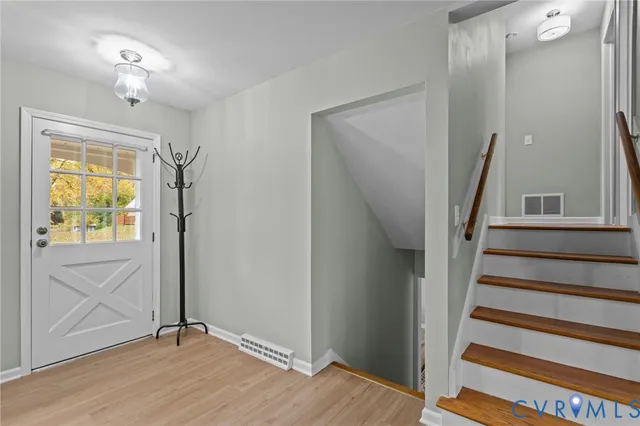 a view of entryway with wooden floor and stairs