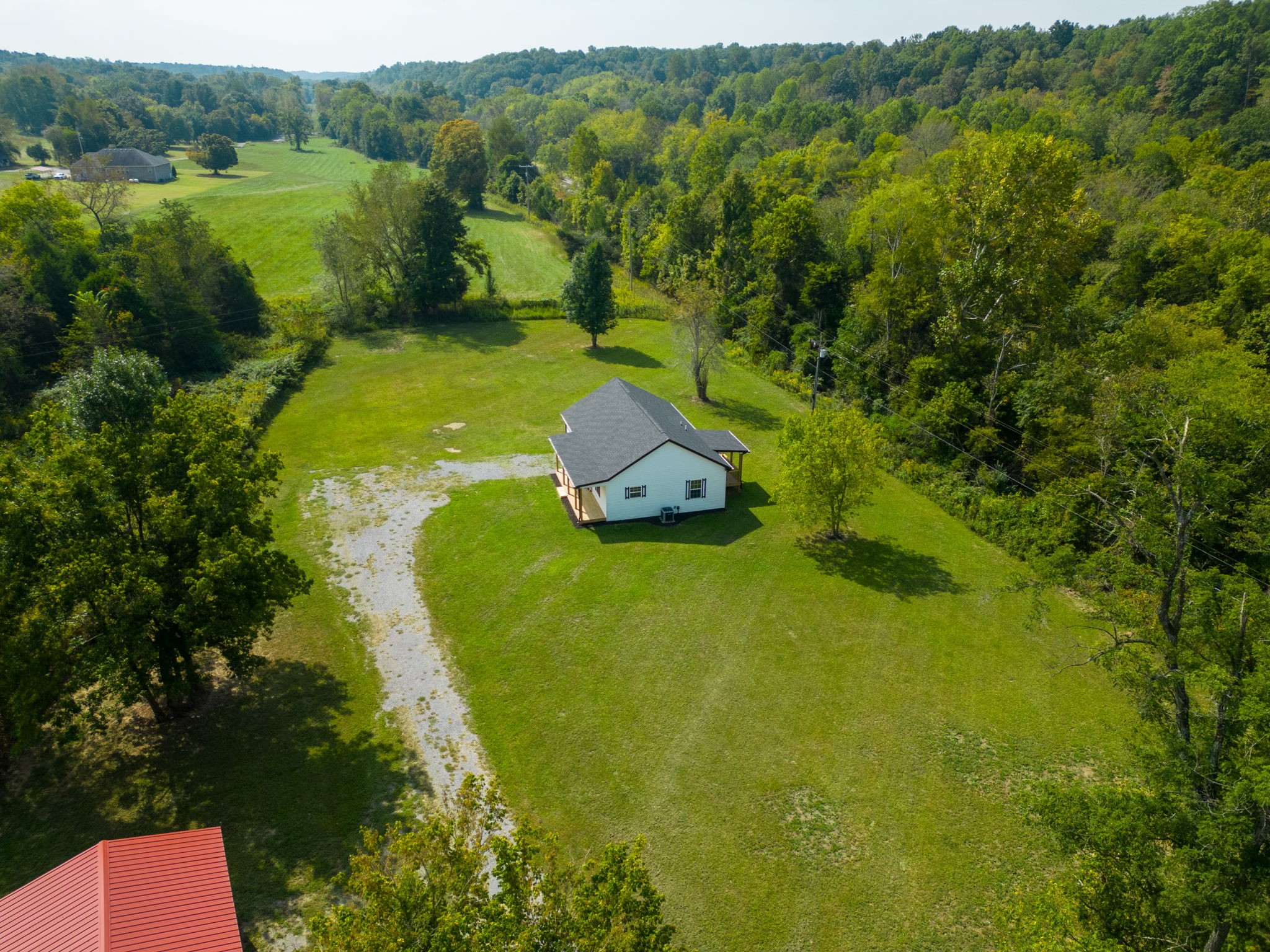 210 B Running Meadows Road Portland, TN 37148 - Photo 54 of 59 a view of a green yard with large trees