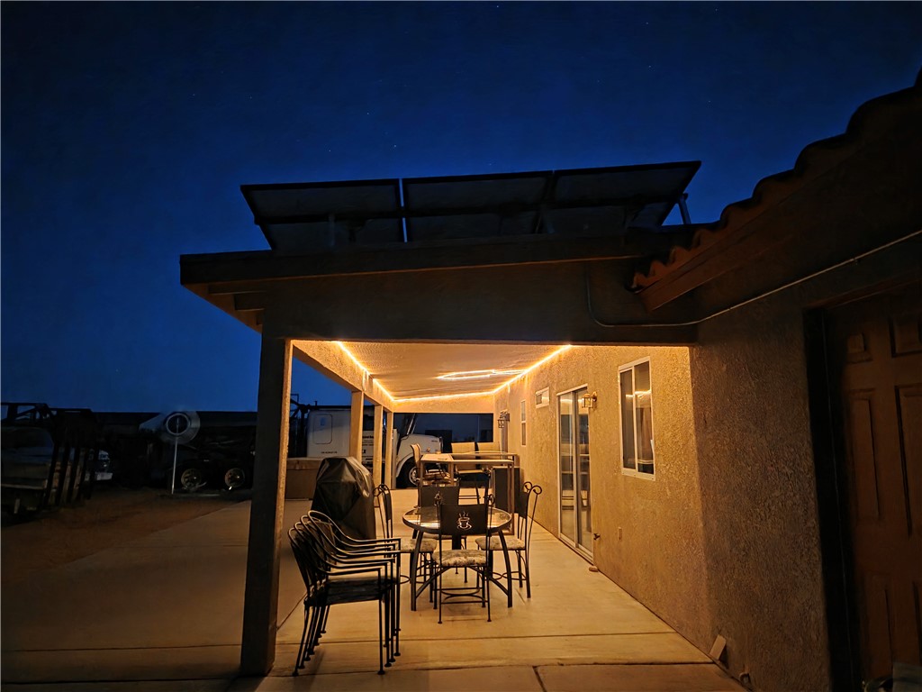 3668 North Neptune Road Golden Valley, AZ 86413 - Photo 36 of 38 This property features an inviting outdoor patio with overhead lighting, a concrete floor, and direct access to the interior via a sliding glass door and an exterior door