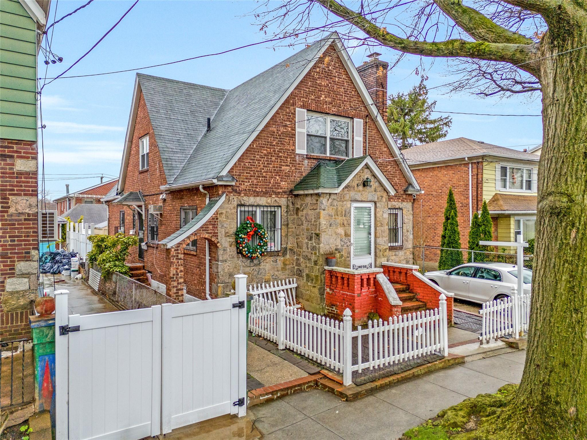 140-50 Quince Avenue Queens, NY 11355 - Photo 4 of 13 a front view of a house with porch