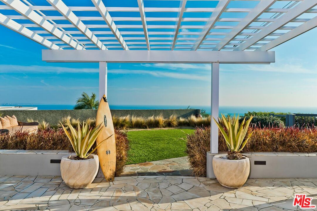 a view of a porch with plants and potted plants