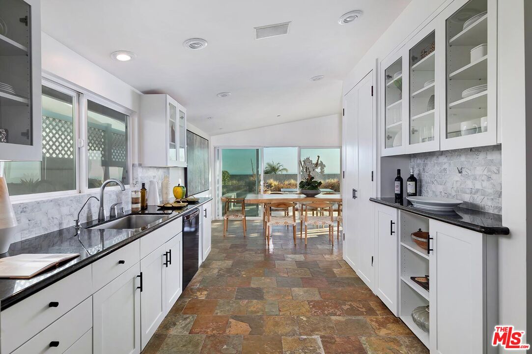 18106 Wakecrest Drive Malibu, CA 90265 - Photo 11 of 29 a large white kitchen with stainless steel appliances granite countertop a lot of counter space and a sink
