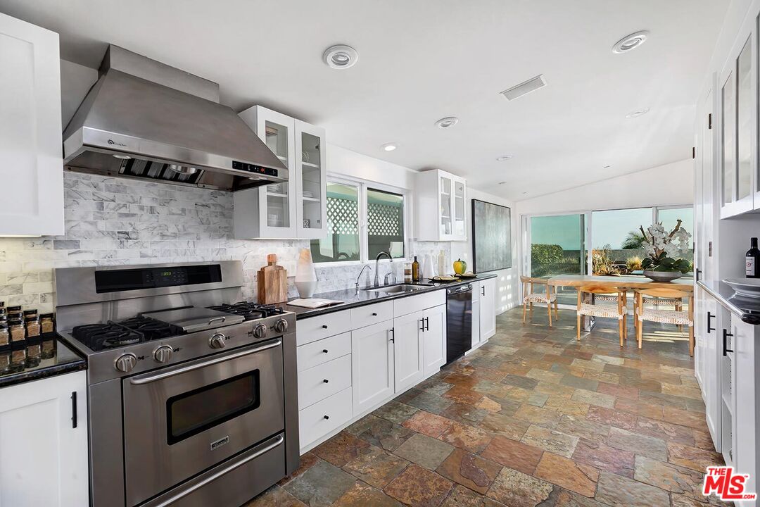 18106 Wakecrest Drive Malibu, CA 90265 - Photo 12 of 29 a kitchen with stainless steel appliances granite countertop a stove and a sink