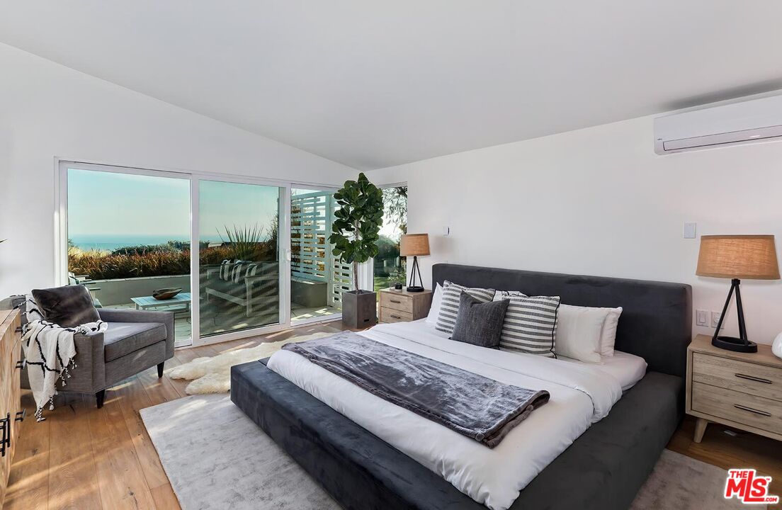 18106 Wakecrest Drive Malibu, CA 90265 - Photo 13 of 29 a bedroom with a bed and glass window