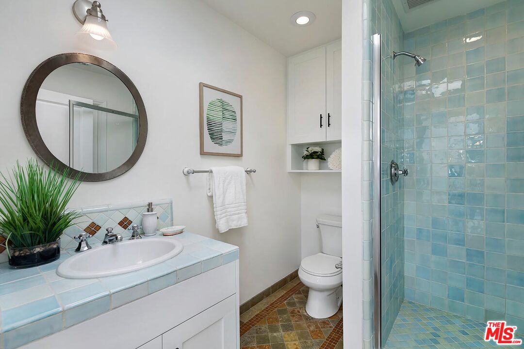 18106 Wakecrest Drive Malibu, CA 90265 - Photo 19 of 29 a bathroom with a toilet a sink and a mirror