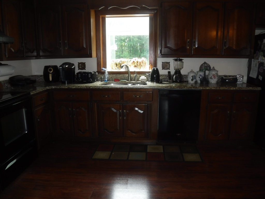 21 Old Orchard Road Hampden, MA 01036 - Photo 6 of 21 a kitchen with a window wooden cabinets and a sink