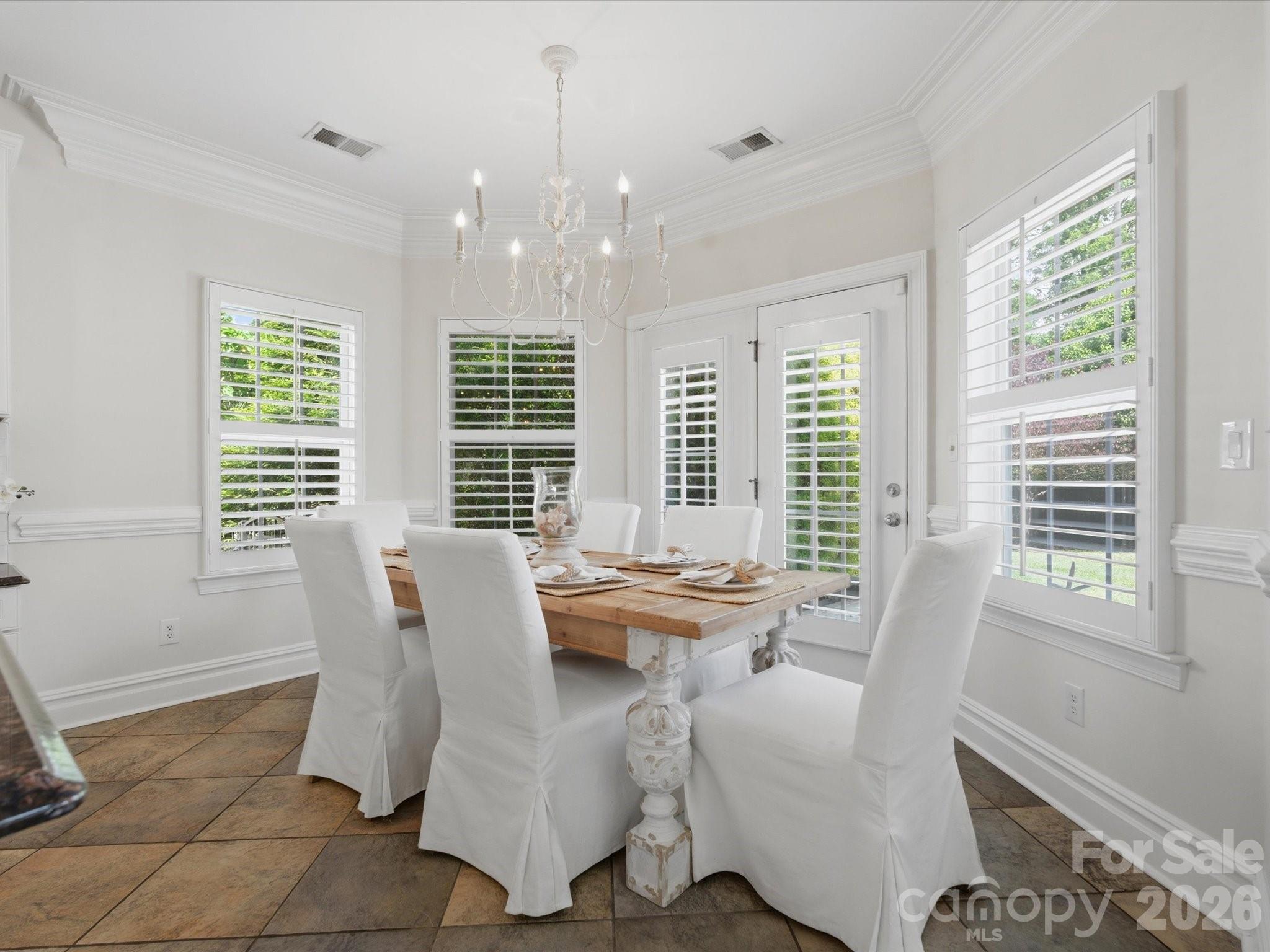 1026 Spanish Moss Road Indian Trail, NC 28079 - Photo 19 of 44 a view of a dining room with furniture and windows
