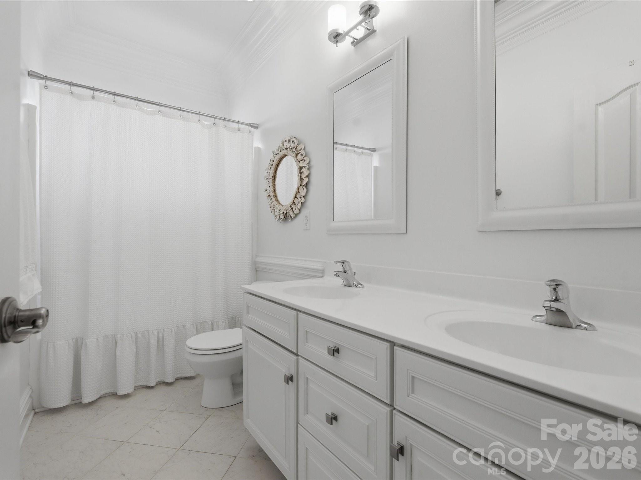 1026 Spanish Moss Road Indian Trail, NC 28079 - Photo 31 of 44 a bathroom with a toilet sink and mirror