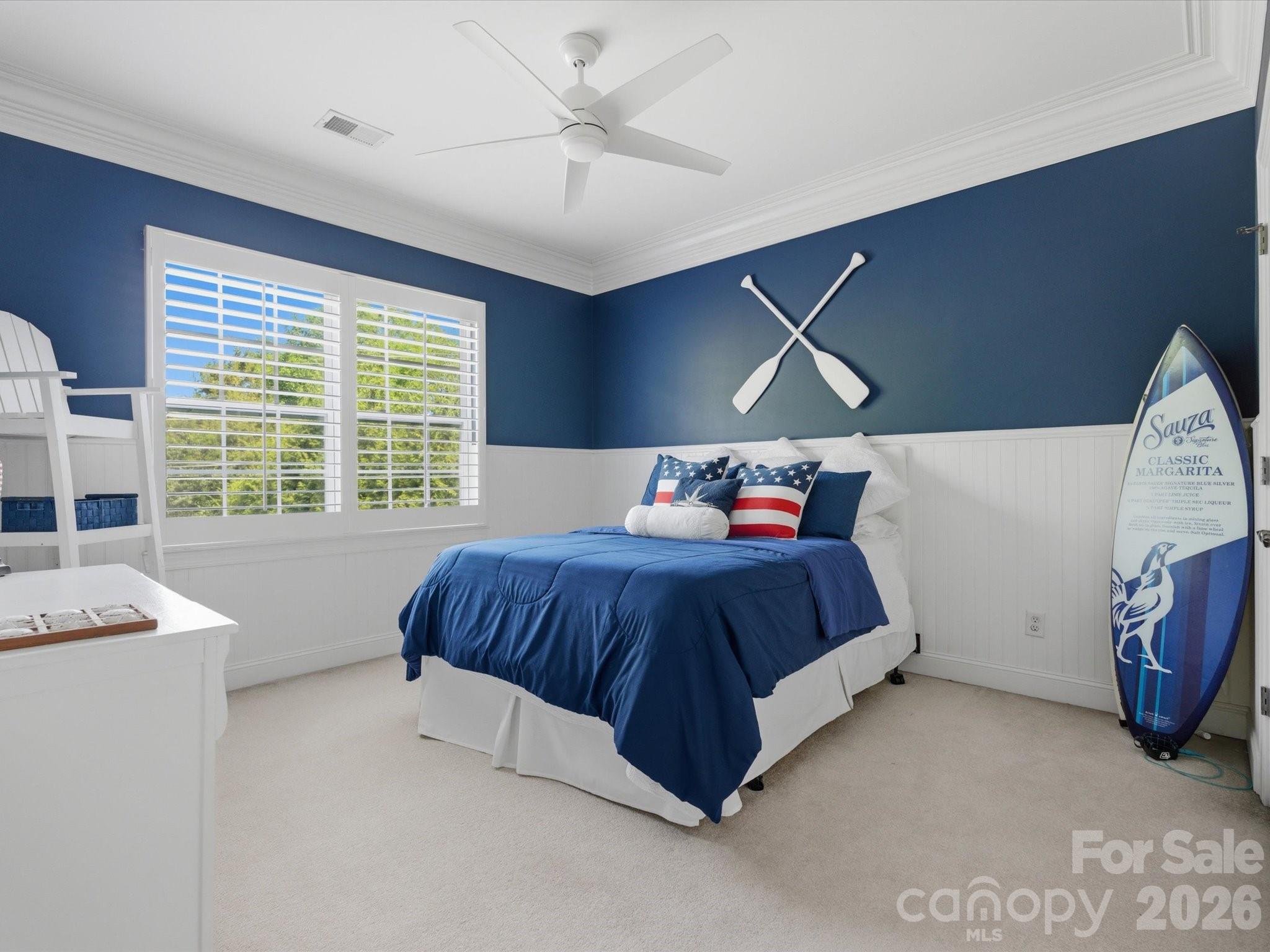 1026 Spanish Moss Road Indian Trail, NC 28079 - Photo 32 of 44 a bedroom with a bed and a chandelier