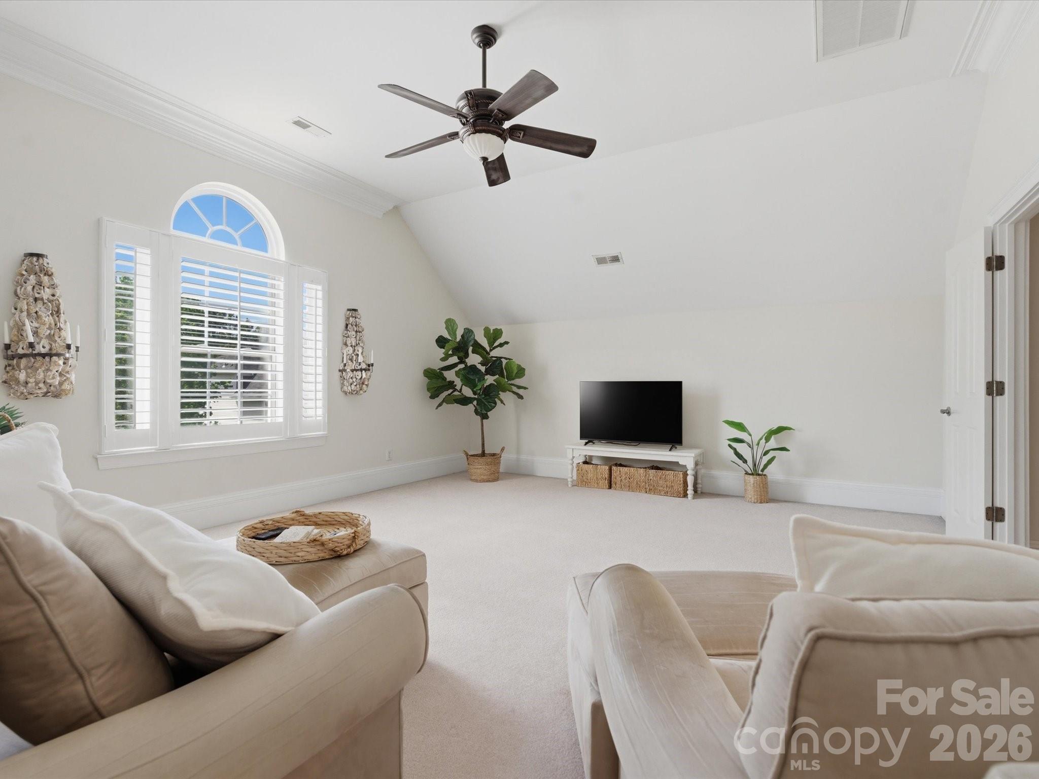 1026 Spanish Moss Road Indian Trail, NC 28079 - Photo 33 of 44 a living room with furniture and a flat screen tv