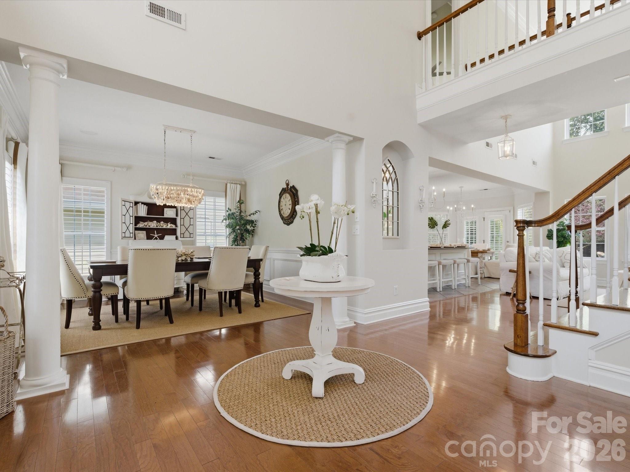 1026 Spanish Moss Road Indian Trail, NC 28079 - Photo 4 of 44 a living room with couches and a dining table with wooden floor