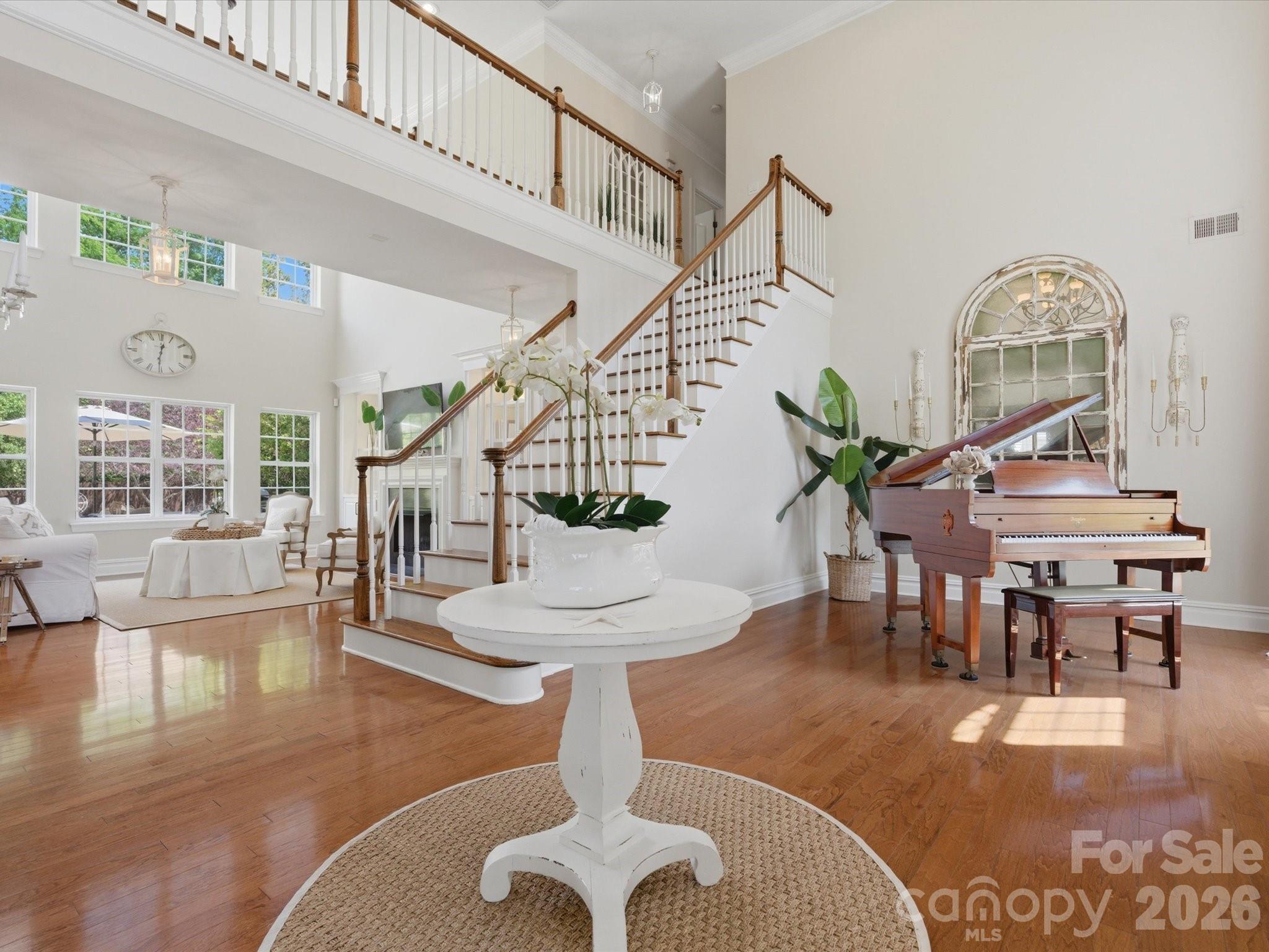 1026 Spanish Moss Road Indian Trail, NC 28079 - Photo 6 of 44 a living room with furniture chandelier and a dining table