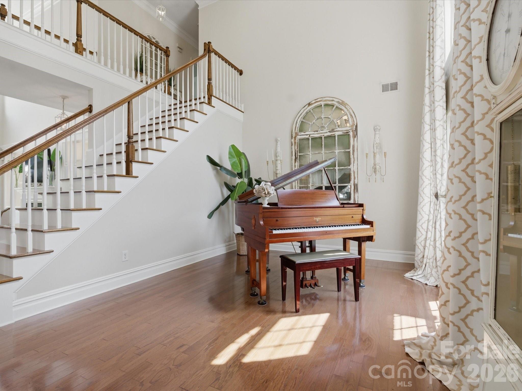 1026 Spanish Moss Road Indian Trail, NC 28079 - Photo 7 of 44 a workspace with wooden floor stairs and a potted plant