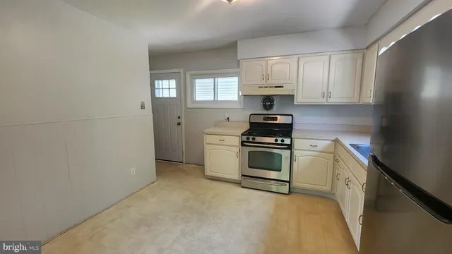 a kitchen with a stove and a refrigerator