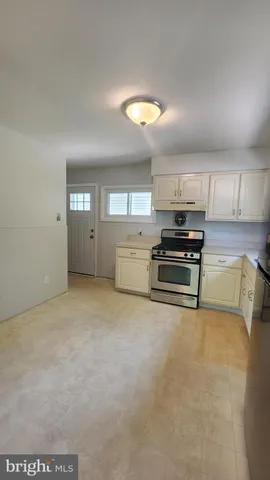 a view of kitchen with microwave and cabinets
