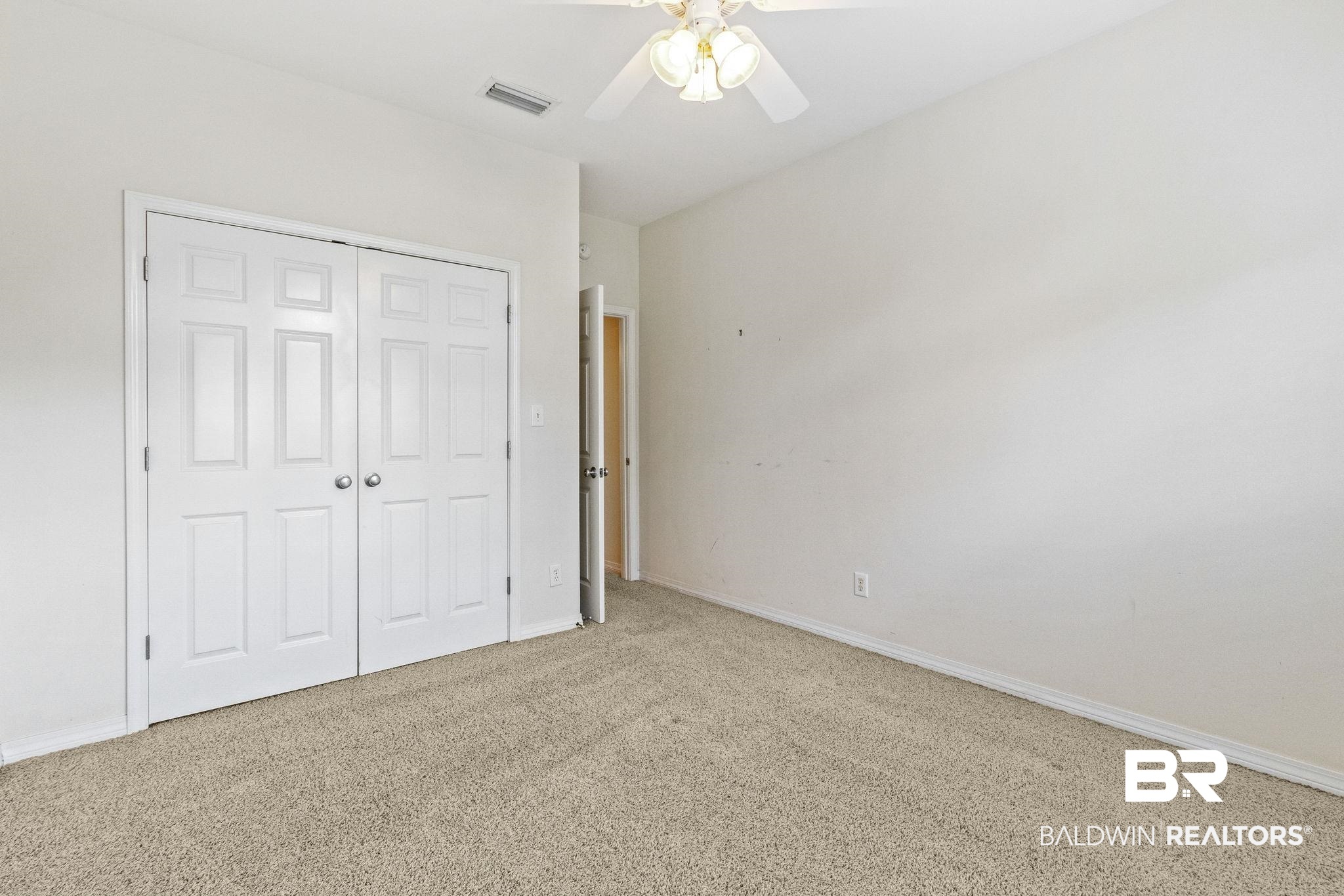 166 Club Drive Fairhope, AL 36532 - Photo 31 of 41 Unfurnished bedroom featuring light colored carpet, ceiling fan, and a closet