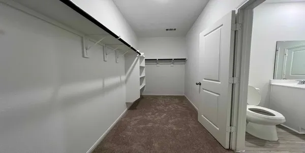 a bathroom with a granite countertop sink a toilet and shower