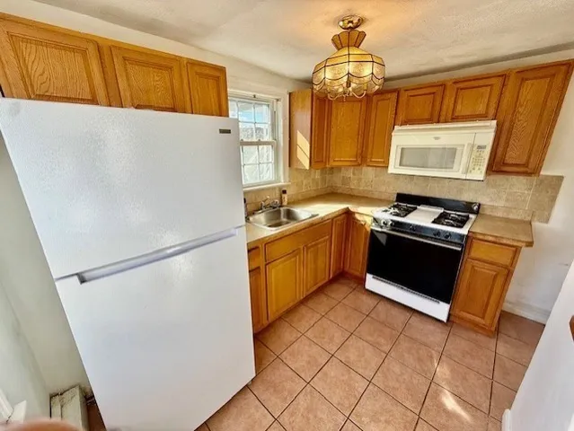 a kitchen with a refrigerator sink and stove