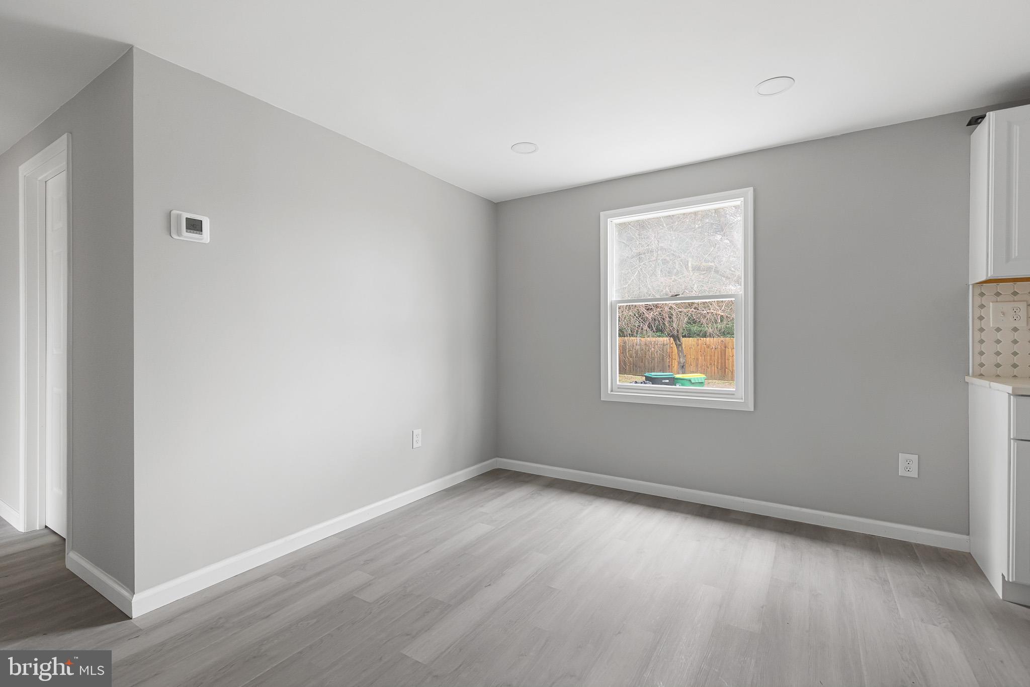 136 State Line Road Wilmington, DE 19803 - Photo 12 of 23 a view of an empty room with wooden floor and a window