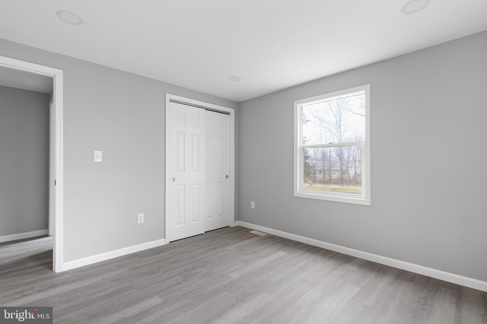 136 State Line Road Wilmington, DE 19803 - Photo 14 of 23 an empty room with wooden floor and windows