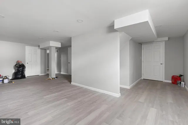 a view of empty room with closet and wooden floor