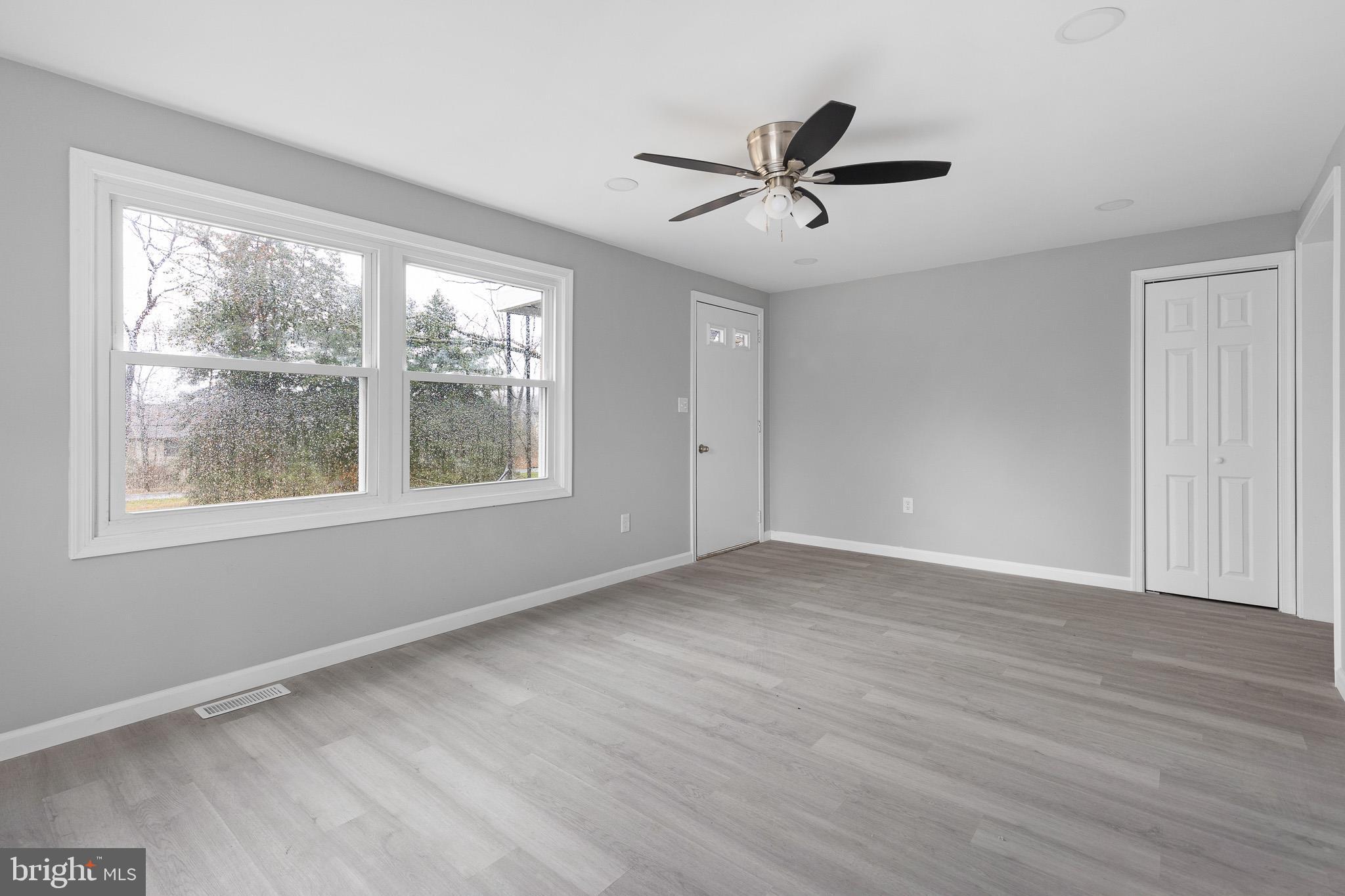 136 State Line Road Wilmington, DE 19803 - Photo 2 of 23 a view of empty room with wooden floor and fan