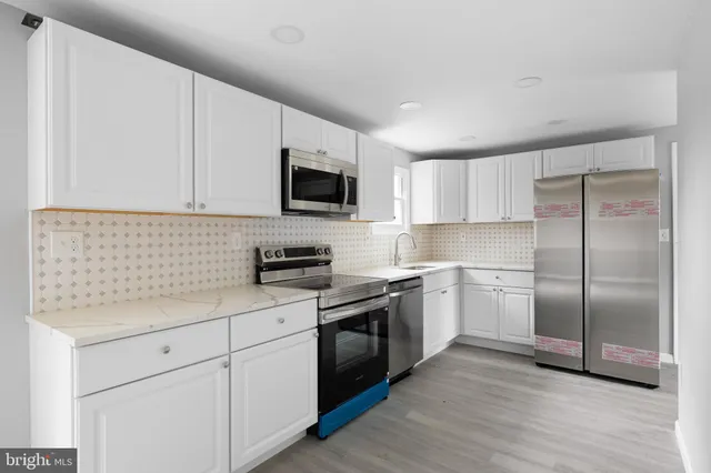 a kitchen with a refrigerator stove and microwave