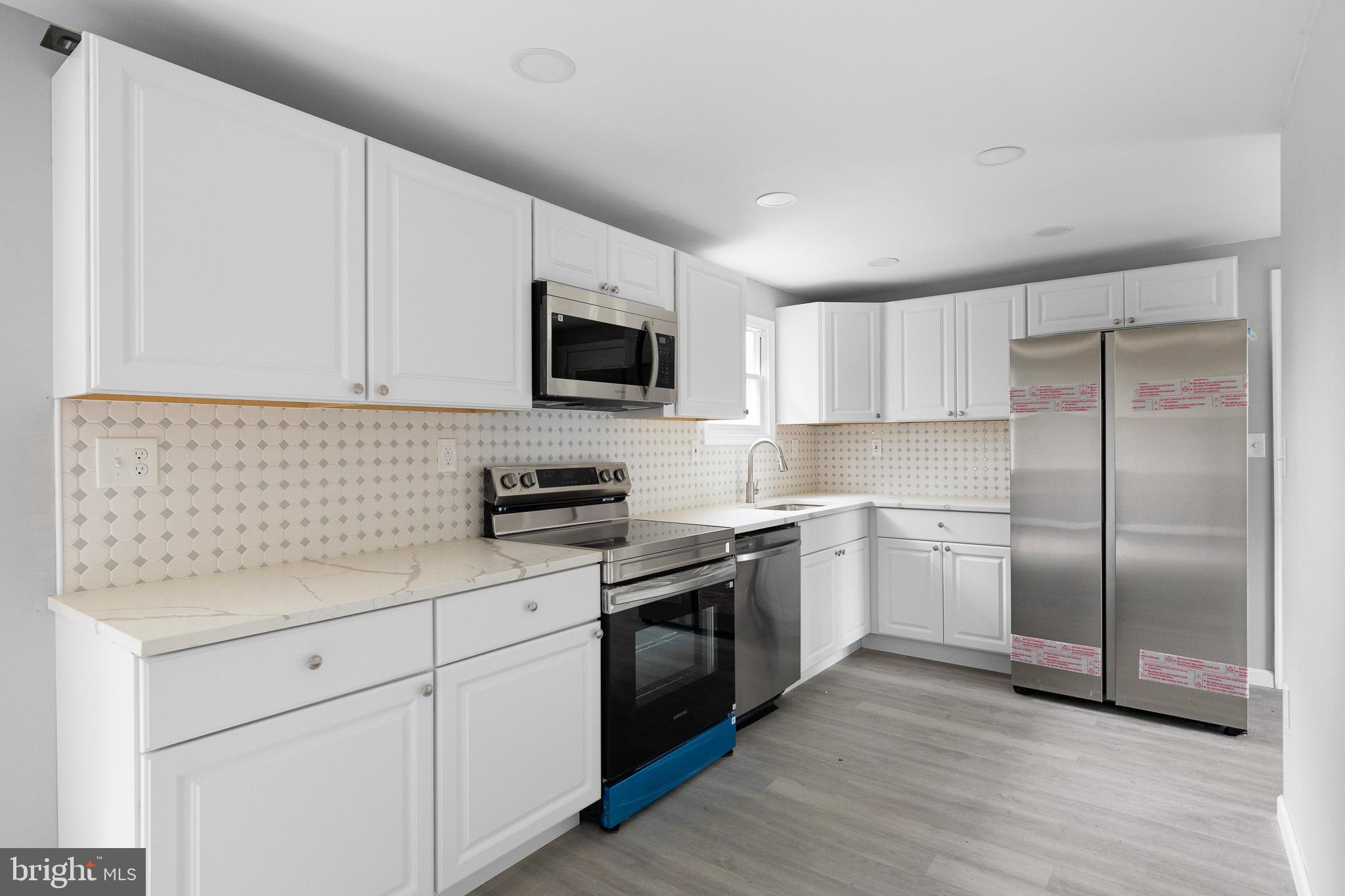 136 State Line Road Wilmington, DE 19803 - Photo 7 of 23 a kitchen with a refrigerator stove and microwave