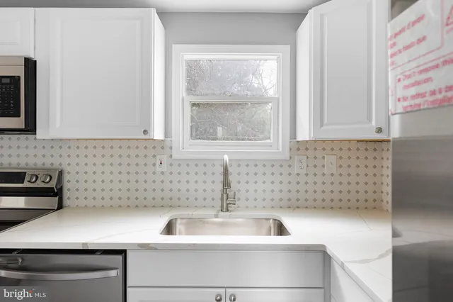a kitchen with a sink and cabinets