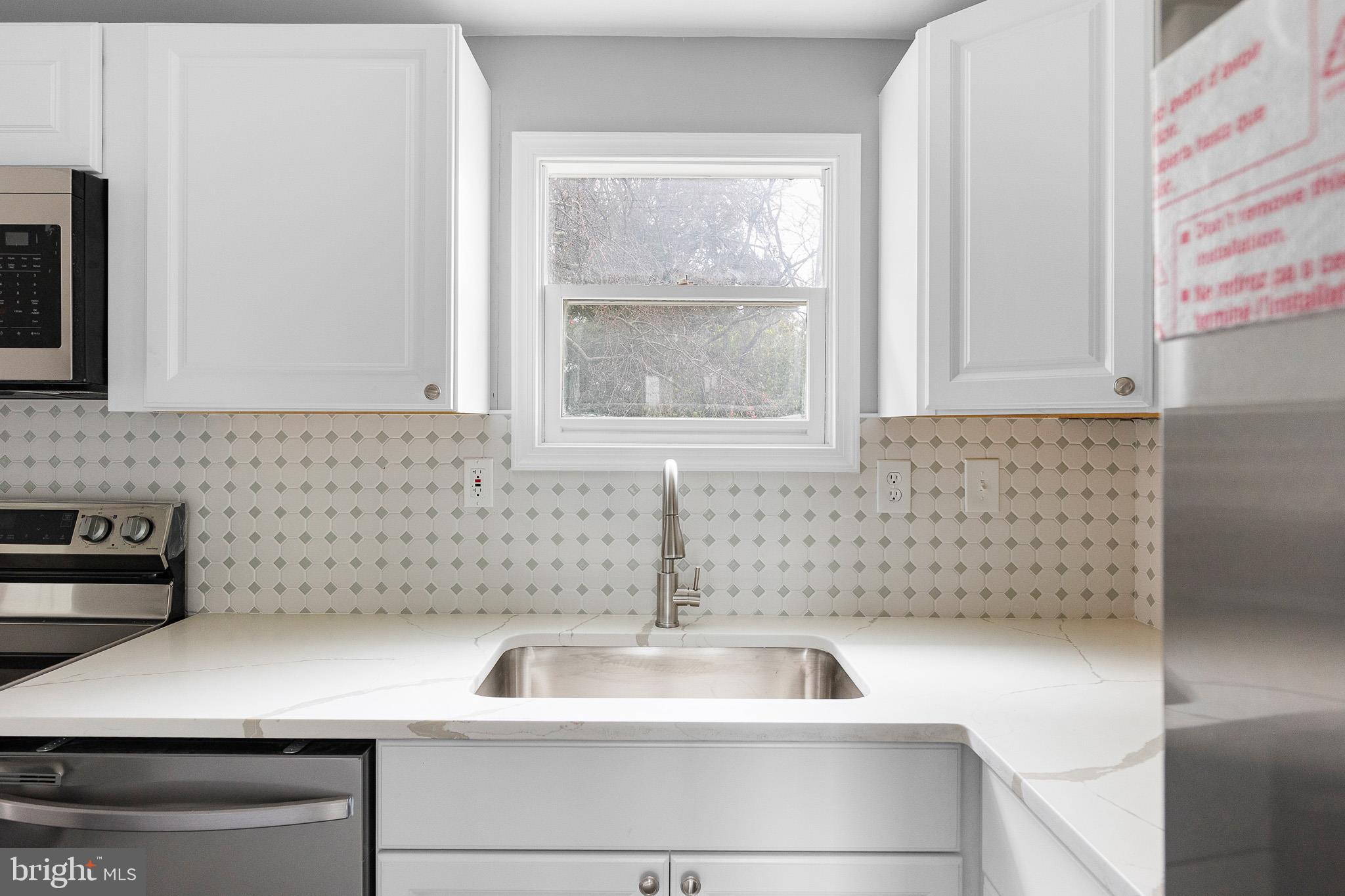 136 State Line Road Wilmington, DE 19803 - Photo 8 of 23 a kitchen with a sink and cabinets