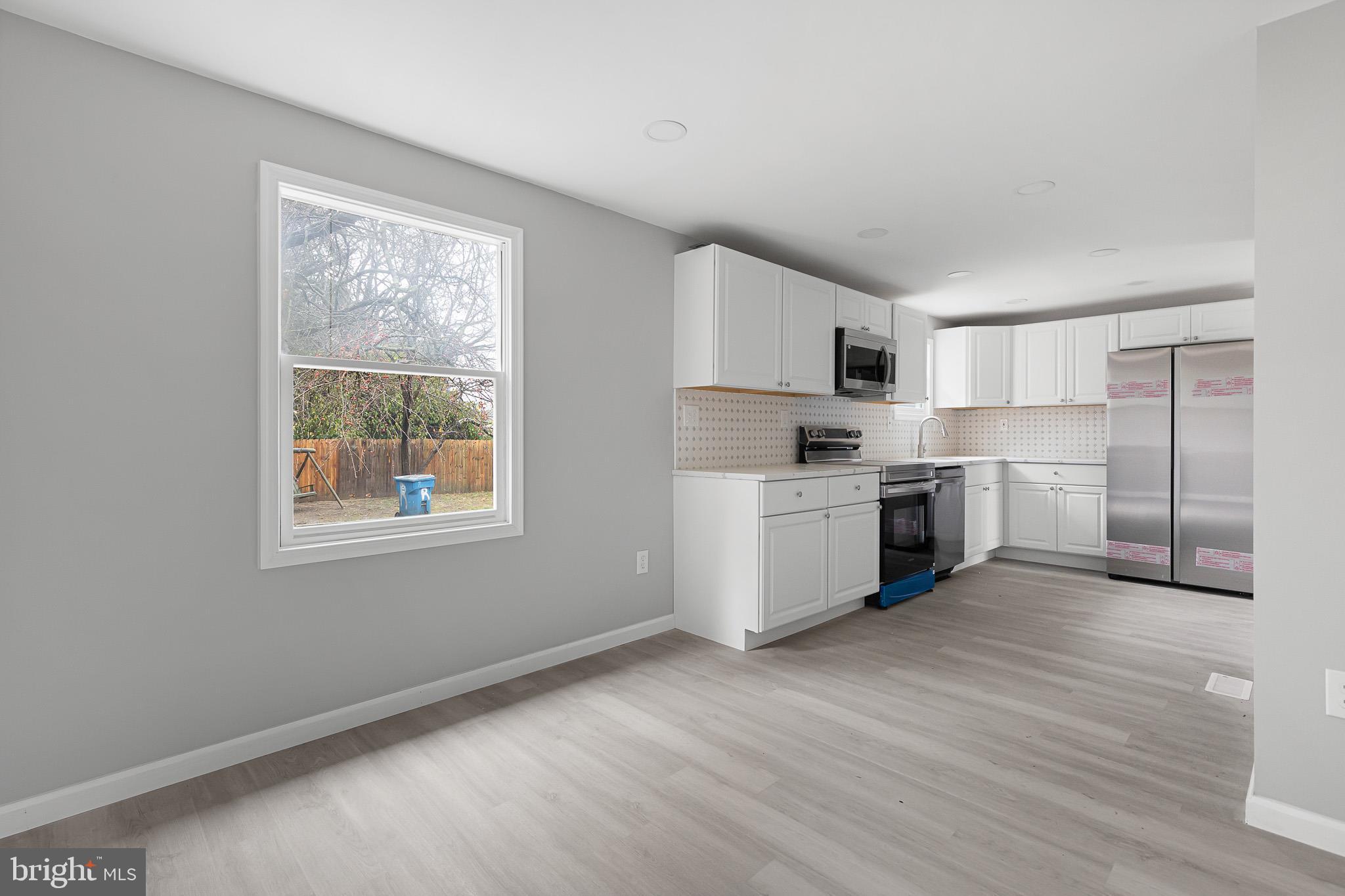 136 State Line Road Wilmington, DE 19803 - Photo 9 of 23 a kitchen with stainless steel appliances granite countertop a stove a sink and a refrigerator