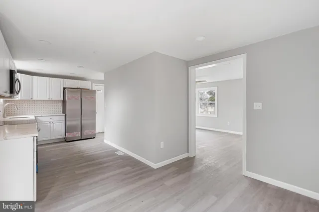 a view of a kitchen with a sink and a refrigerator