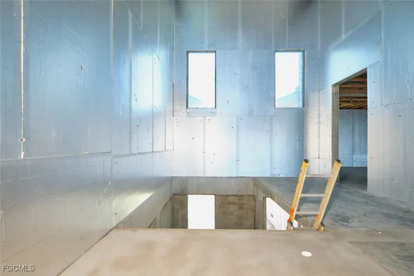 a view of a hallway with a table and chairs