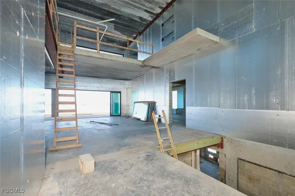 a view of a room with wooden floor and stairs