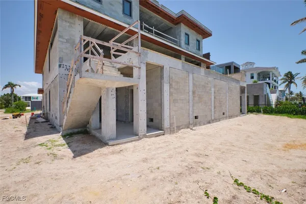 a view of a house with a wooden fence