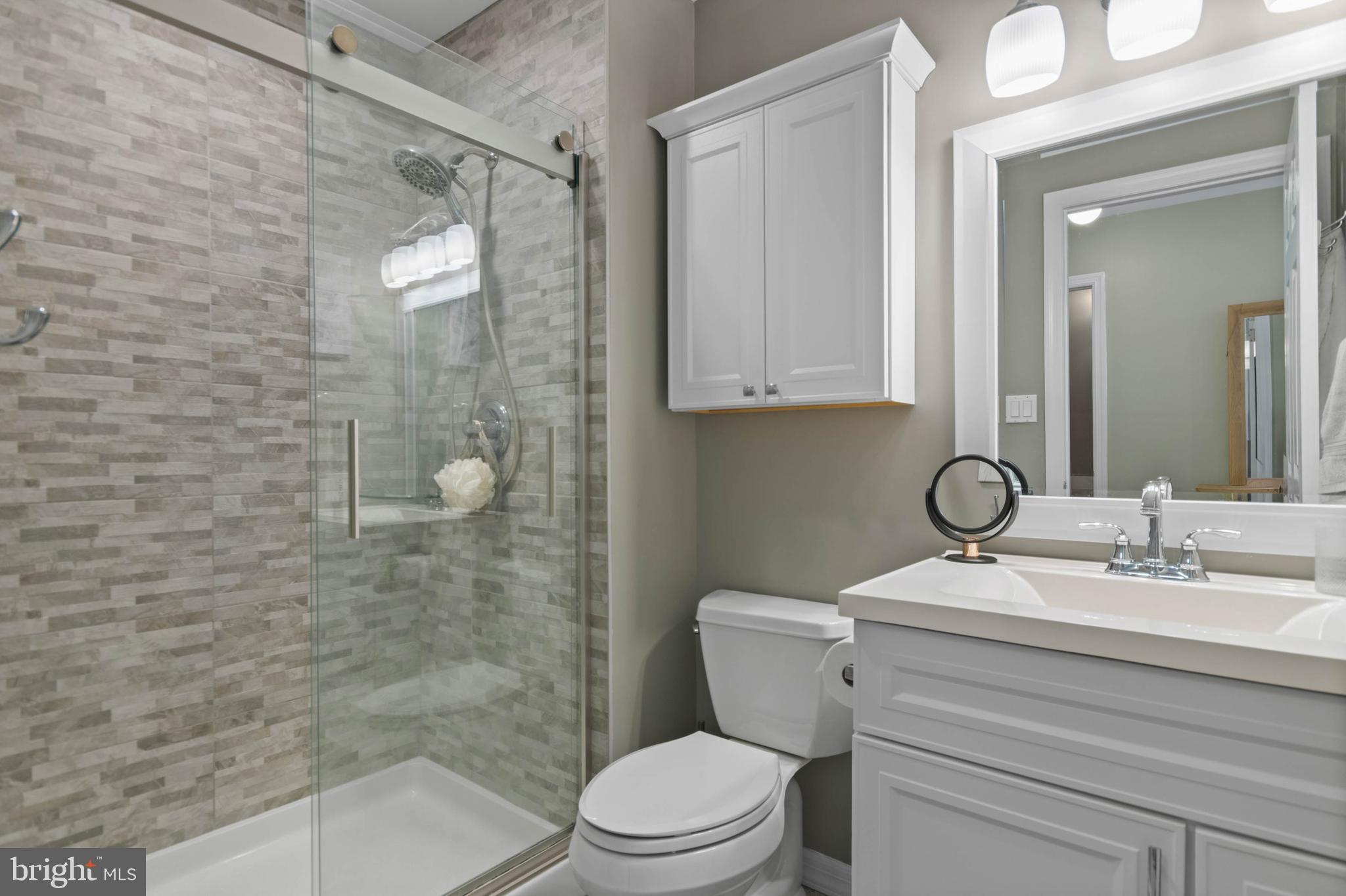 24 Jacob Court Ewing, NJ 08628 - Photo 13 of 14 a bathroom with a sink a toilet and shower