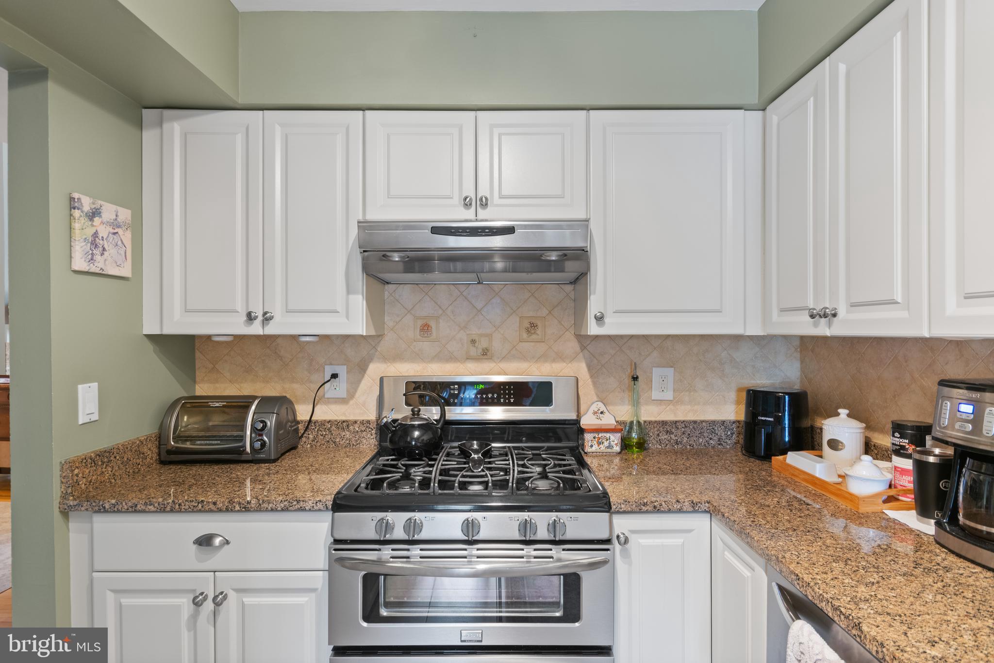 24 Jacob Court Ewing, NJ 08628 - Photo 4 of 14 a kitchen with granite countertop white cabinets and stainless steel appliances