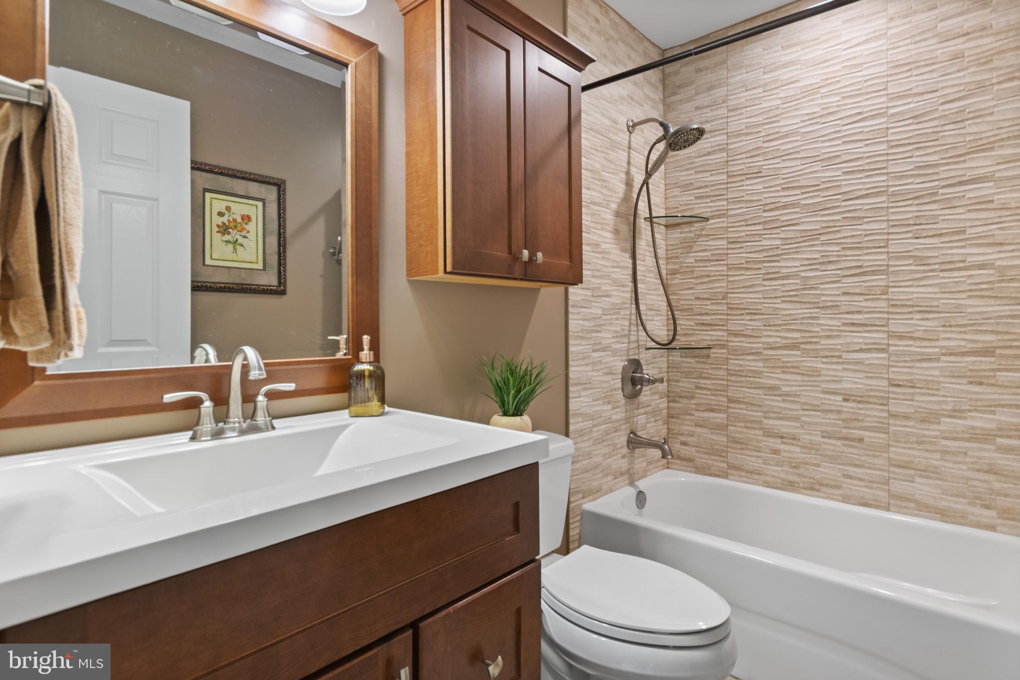 24 Jacob Court Ewing, NJ 08628 - Photo 10 of 14 a bathroom with a sink a toilet and shower
