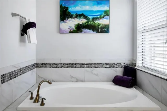 a bathroom with a bathtub and a window