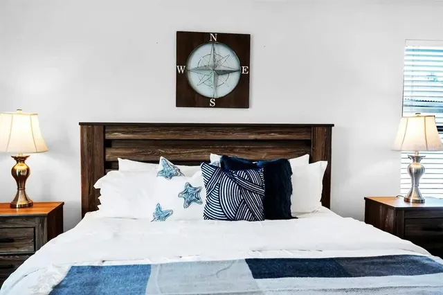 a bedroom with a bed and a painting on wall