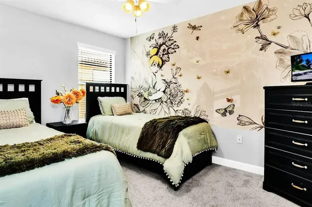 a bedroom with two beds and a window