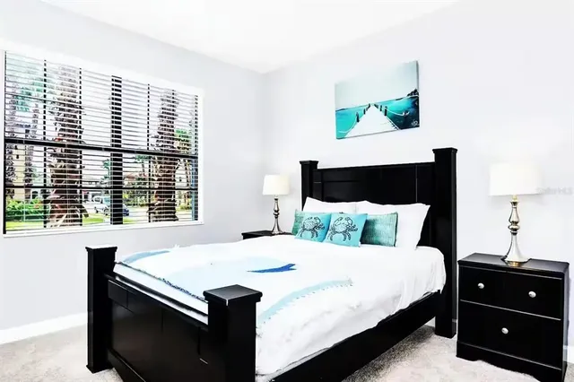 a bedroom with a bed and a night stand