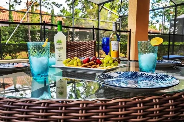 a swimming pool with lawn chairs and wooden fence