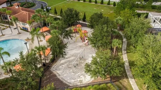 an aerial view of a houses with swimming pool